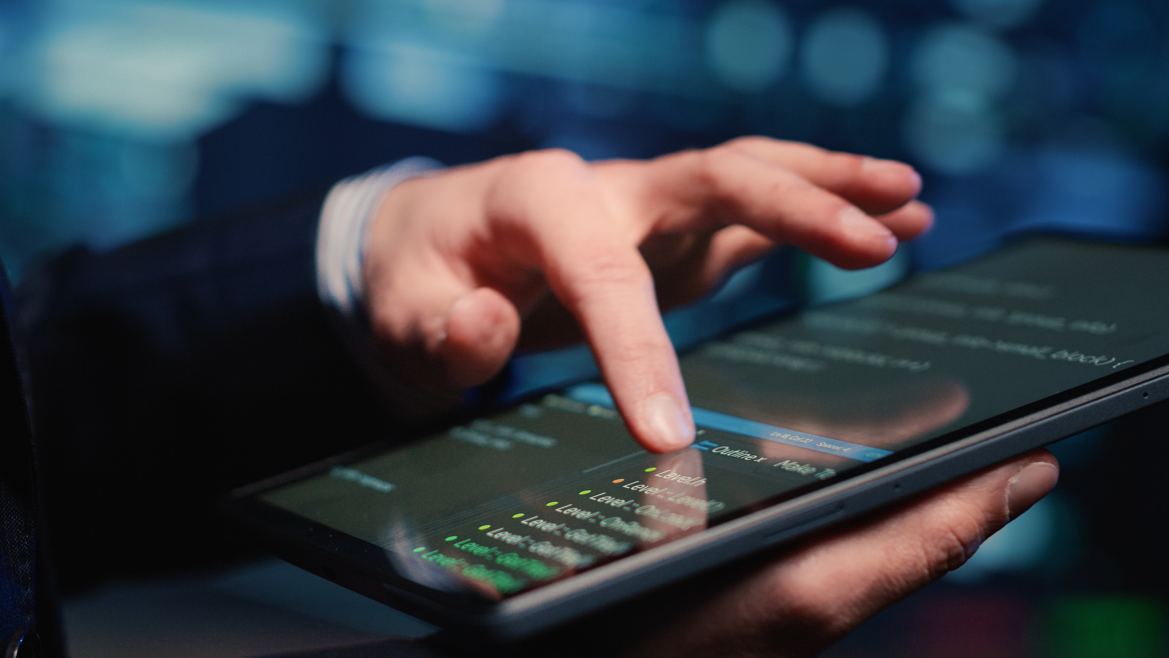 Male system administrator inspecting big data on tablet